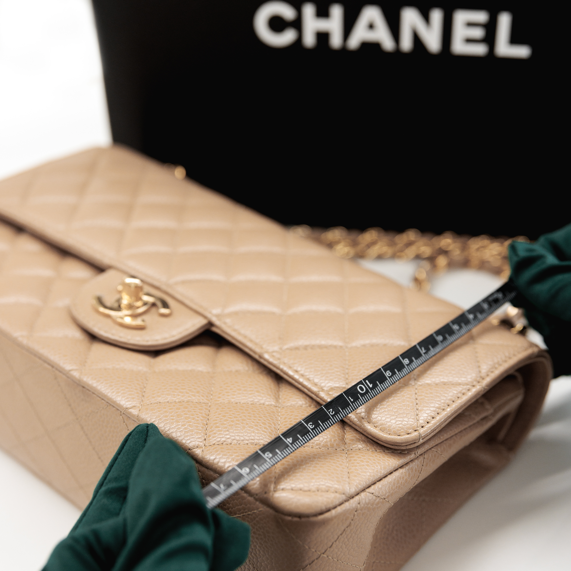 Pre-loved Chanel Beige Caviar Leather Medium Classic Double Flap Bag with gold hardware being authenticated and quality checked by Xupes team.