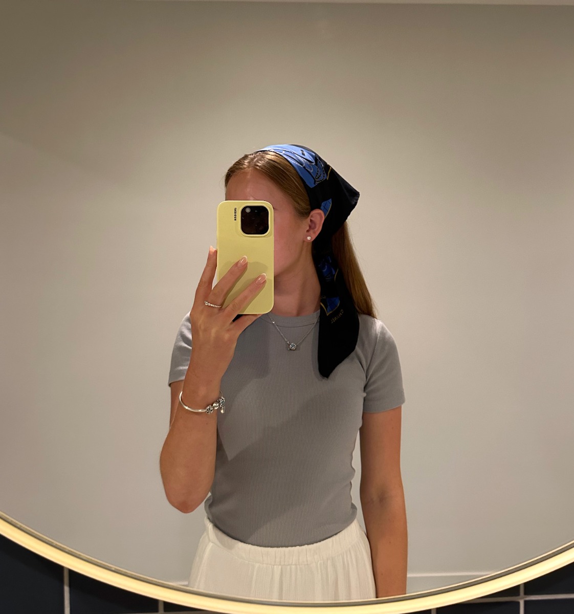 Xupes Junior Graphic Designer, Emily Raymond, wearing vintage Chanel Black and Blue Flap Bag scarf as a bandana.